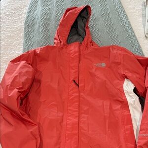 The North Face orange rain jacket